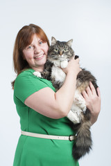 A woman holds a big fluffy cat..