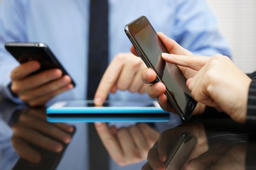 businessman and businesswoman working and using smart mobile pho