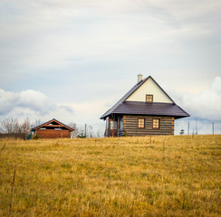 Wooden Village House on Grass Hill