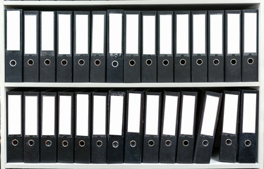 Black binders on shelf