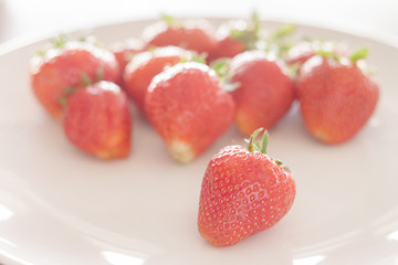 Fresh strawberries on white plate