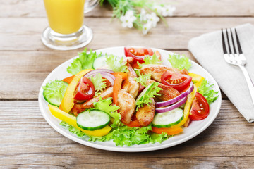 Salad with grilled chicken fillet tomatoes peppers and cucumber