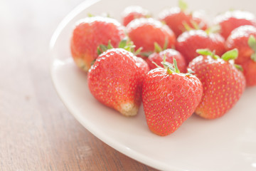 Fresh strawberries on white plate