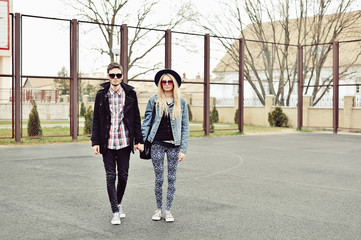 Young stylish couple outdoor fashion portrait