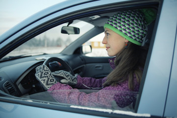 female driver in the car in winter