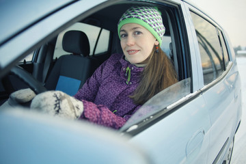 female driver in the car in winter