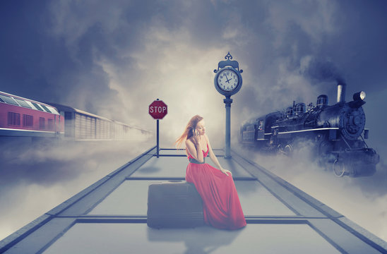 woman waiting train on platform railway station talking on phone