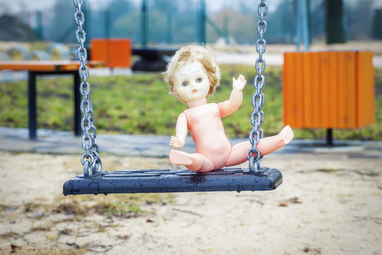 Old abandoned doll on a swing