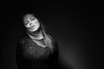 Portrait of a beautiful girl on a black background.