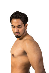 Fototapeta premium A young and fit male model posing his muscles