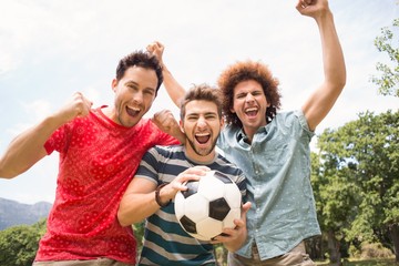 Happy friends in the park with football