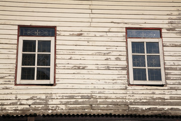 Fototapeta na wymiar Windows and old wooden wall of cottage