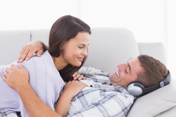 Couple looking at each other on sofa