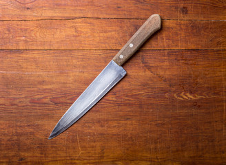 Knife on rustic kitchen table with copy space