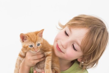 Cute boy holding while looking at kitten