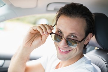 Man driving and smiling at camera