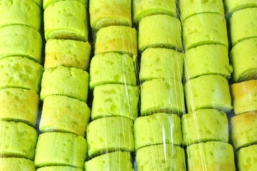 Closeup of green Swiss roll under plastic wrap, Green roll cake
