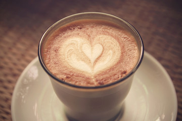 Coffee latte art on Tablecloth texture background - Vintage effe