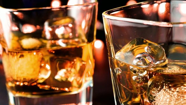 barman pouring whiskey on bar table, whisky relax time concept
