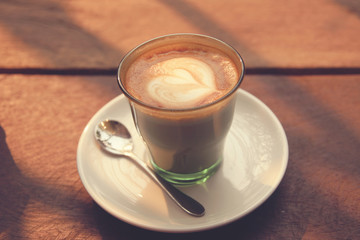 Coffee latte art on the wood texture background - Vintage effect