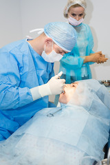 Dentists during surgery for implant placement