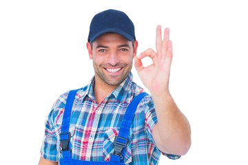 Portrait of smiling repairman gesturing okay - obrazy, fototapety, plakaty