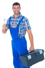 Smiling male repairman with toolbox and spanner