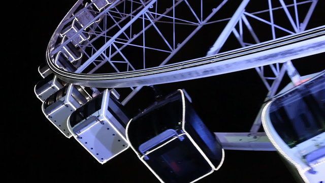 happy rotating Ferris wheel at night, black background