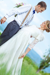 happy bride and groom on the green field