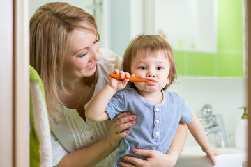 mother teaching kid teeth brushing