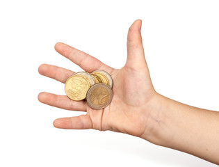 Coins in child's hand on white background