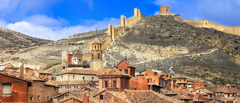 Spain Albarracin medieval terracotta town 9K. Ancient red stone city with defensive fortress walls on hill. Scenic Aragon travel destination. World Print 9000px panorama summer scenery