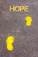 Yellow footsteps on sidewalk towards Hope message