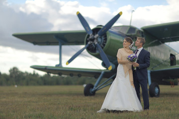 Fototapeta na wymiar Wedding couple in love vintage aircraft