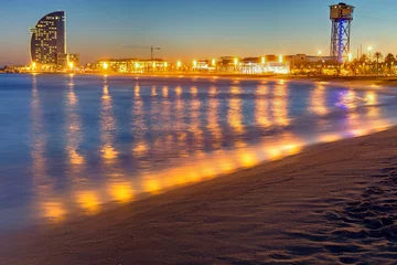 Fotobehang Het strand van Barcelona na zonsondergang © elxeneize