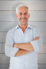 Composite image of smiling man posing with arms crossed