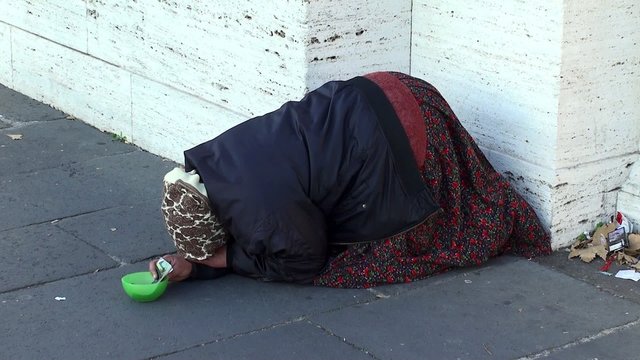 Pauper woman begging on the street of Rome