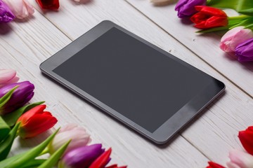 Tulips forming frame around tablet