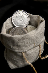 Old silver dollar of USA in sack bag