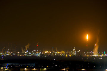 Petrochemical factory with flame at night