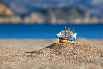Souvenir sailing vessel on a beach © Maxim Malevich