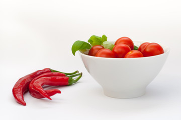 Fresh cocktail tomatoes in bowl and chilli