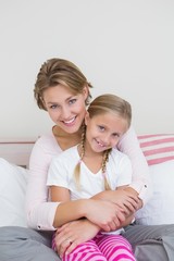 Mother and daughter smiling at camera