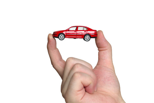 Hand holding red car model