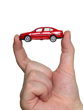 Fingers holding red car model
