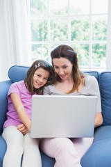 Fototapeta na wymiar Mother and daughter using laptop