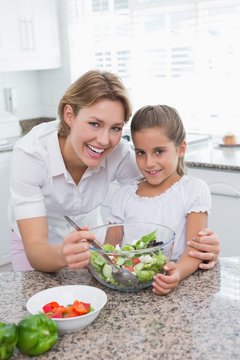 Mother and daughter preparing salad