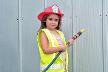 Fototapeta premium Child girl in fireman costume