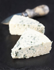 Blue cheese on black background