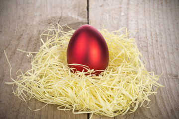 Red ester egg on a wooden bacground